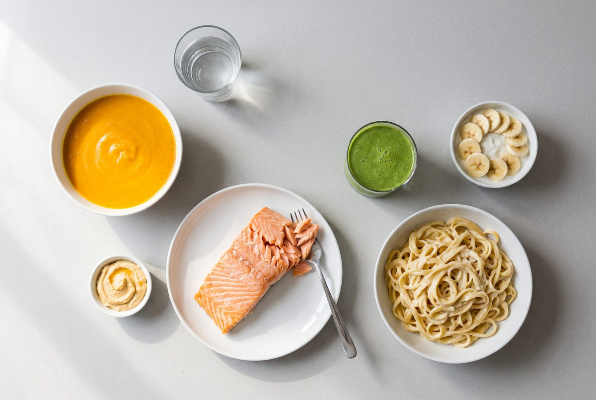 Weiche Kost nach der Wurzelbehandlung: Suppe, Lachs, Nudeln, Smoothie, Skyr und Hummus auf einem Tisch